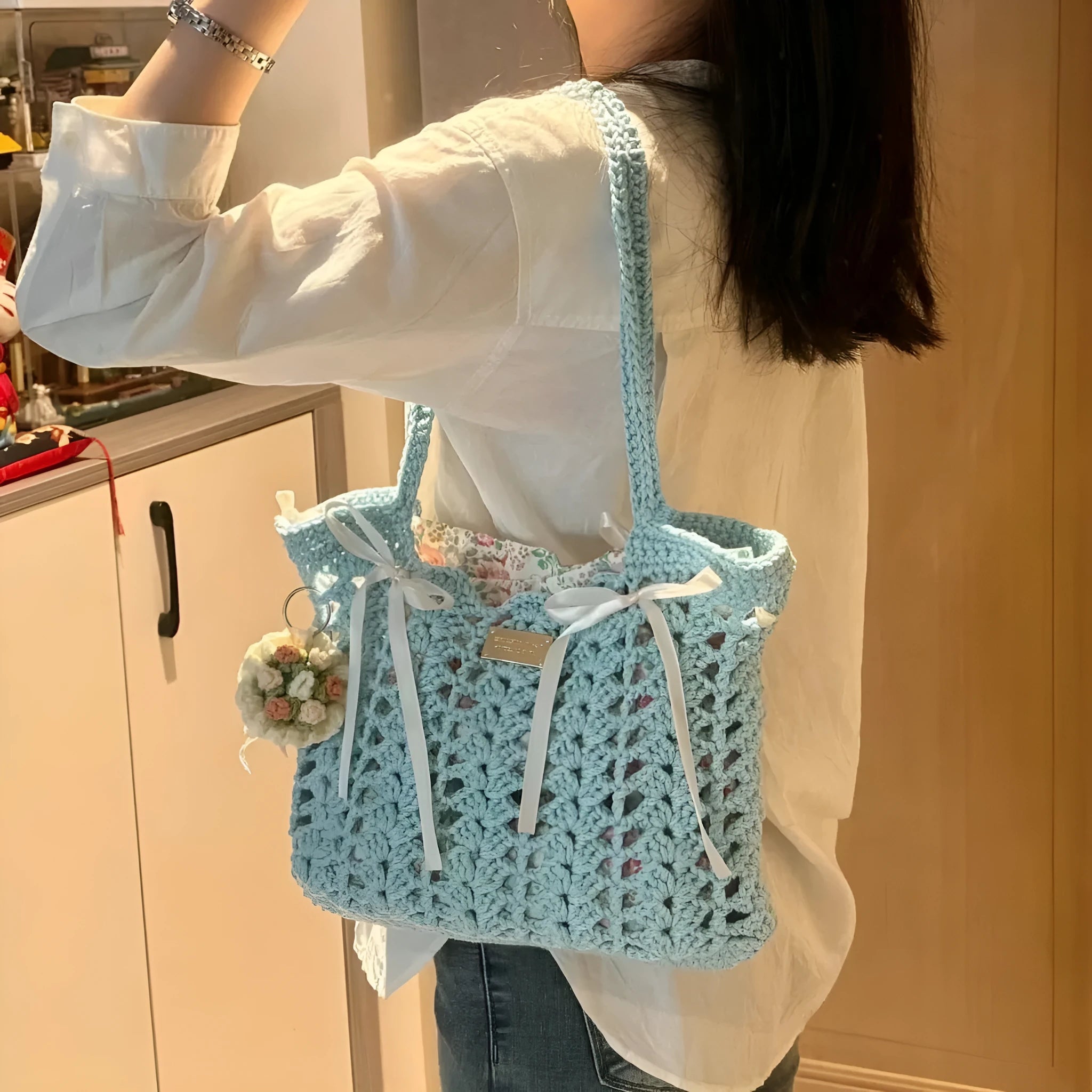 Handwoven wool summer tote bag with a floral patterned design.