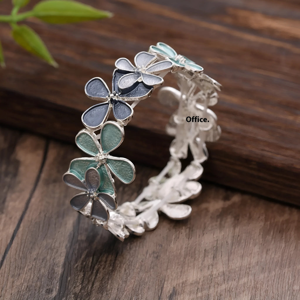 Zinc alloy flower elastic bracelet for women with dripping oil finish in blue, black, or colourful design.
