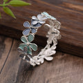 Zinc alloy flower elastic bracelet for women with dripping oil finish in blue, black, or colourful design.
