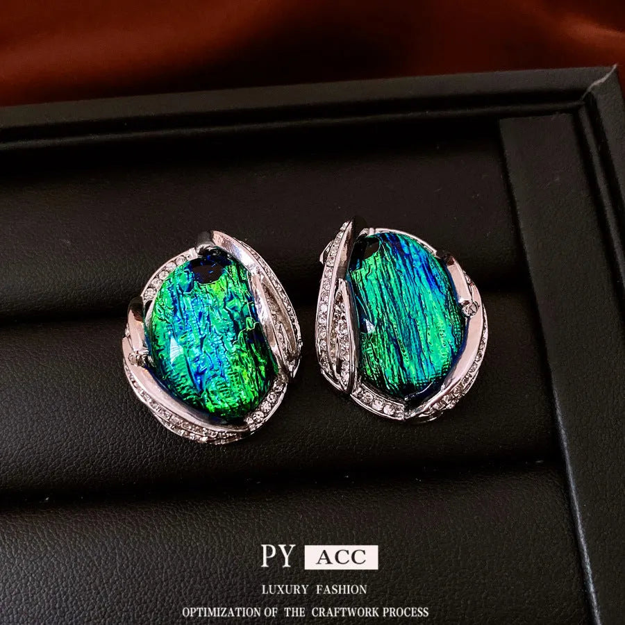 Silver resin stud earrings with rhinestone encrusting and irregular retro shape in silver needle green