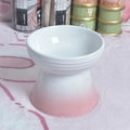 White ceramic pet bowl with a high foot base and wide, shallow eating area for dogs and cats