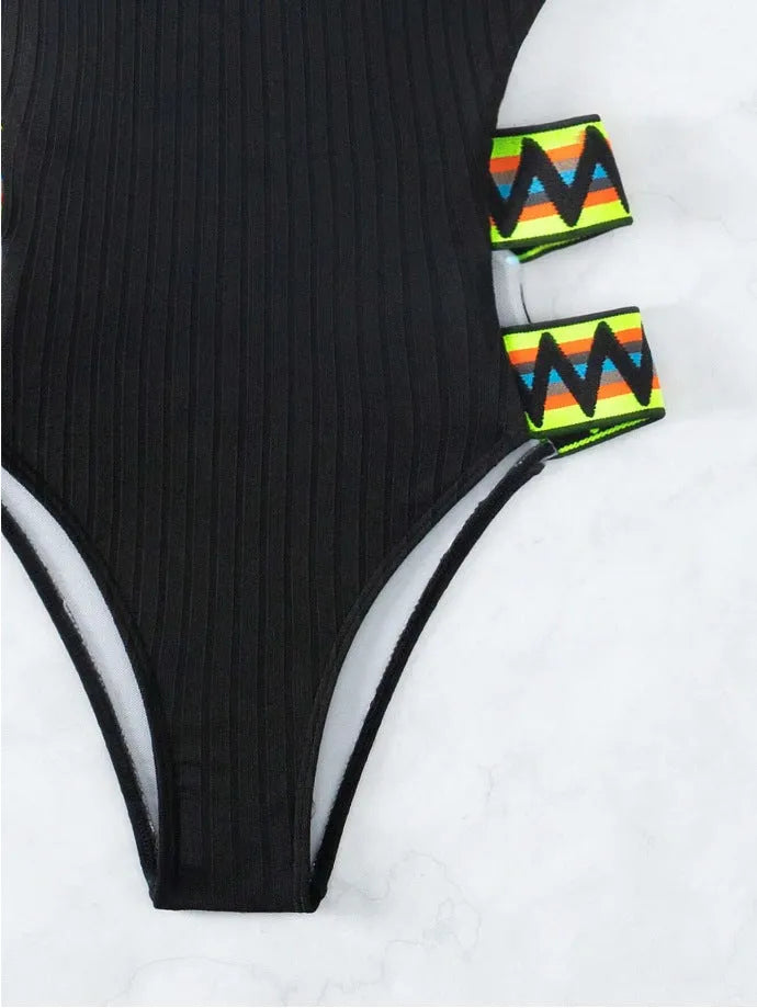 Solid colour women's one-piece swimsuit in black or orange, made from polyester fabric.