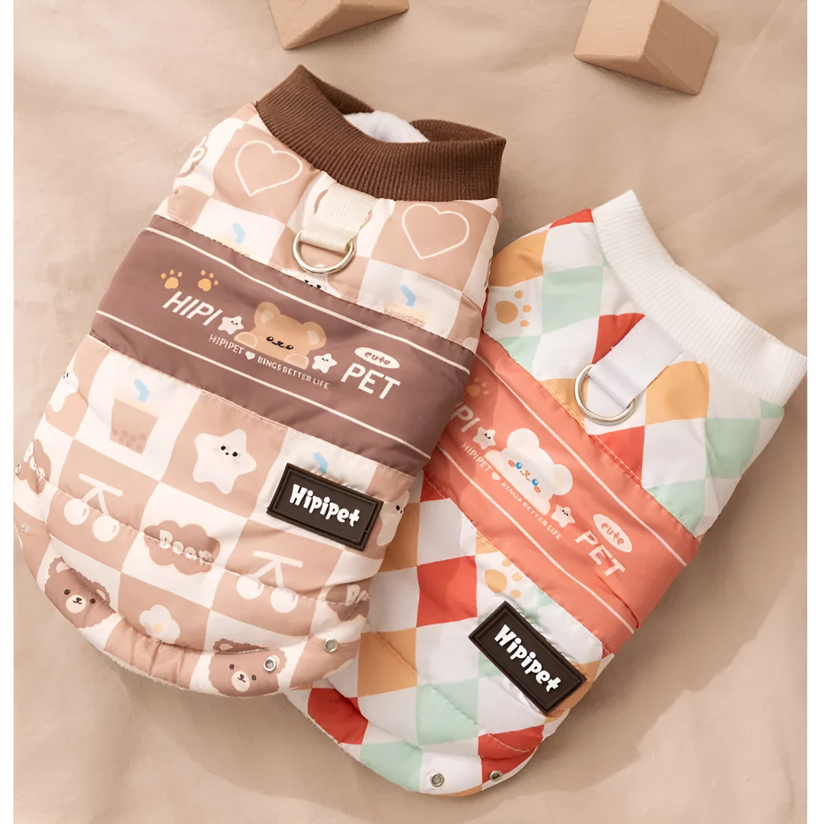 Quilted two-legged pet vest with leash ring in brown bear print or geometric red-green, sizes XS-XXL.