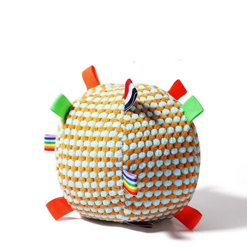 Blue and yellow textured rubber dog ball with holey lattice design, 17cm in diameter, on a wooden floor.