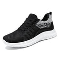 Women's low-top lace-up sneakers in black mesh with a round toe and soft PVC sole.