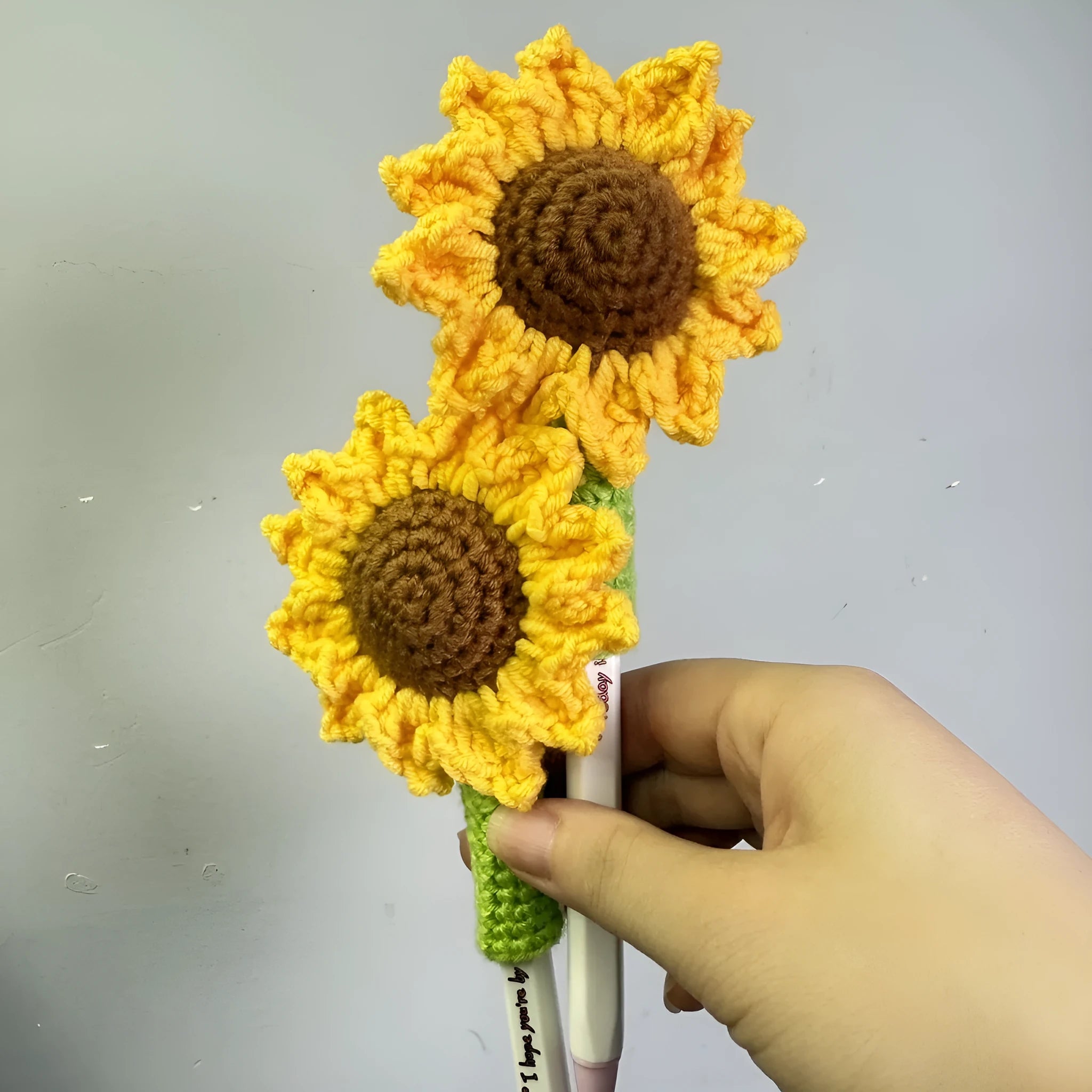 Hand-woven sunflower pen cover for teachers with crochet construction
