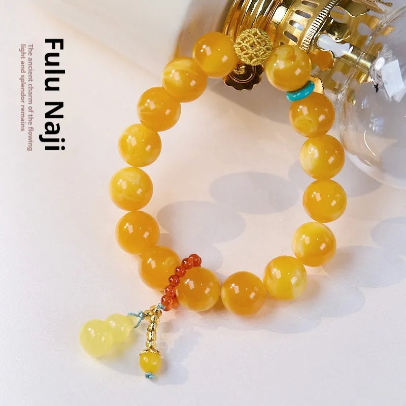 Natural beeswax Gourd Fu Lu bracelet in two sizes 12mm and 6mm on plain background