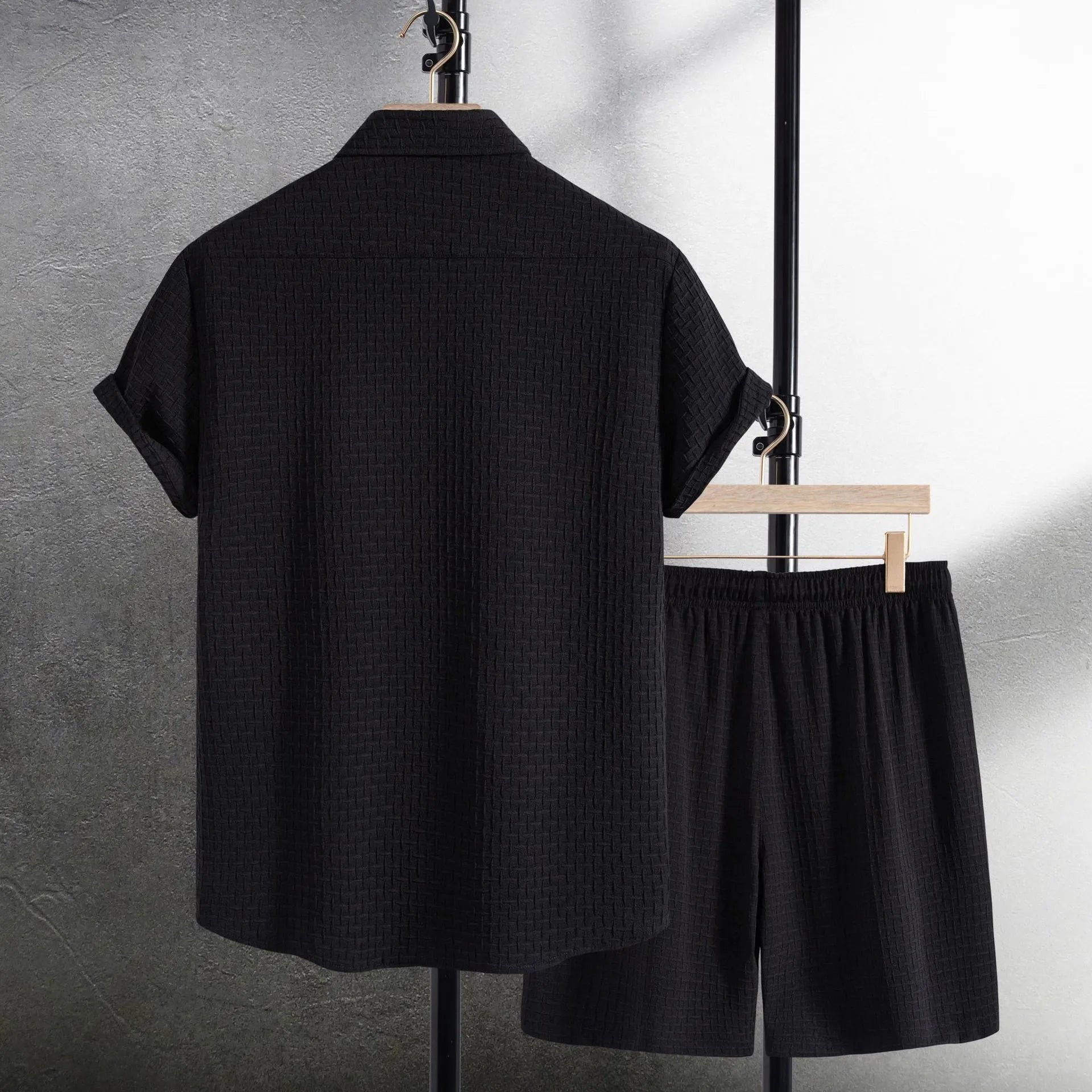 Men's white cotton blend beach suit with short sleeve shirt and loose-fitting shorts on a hanger.