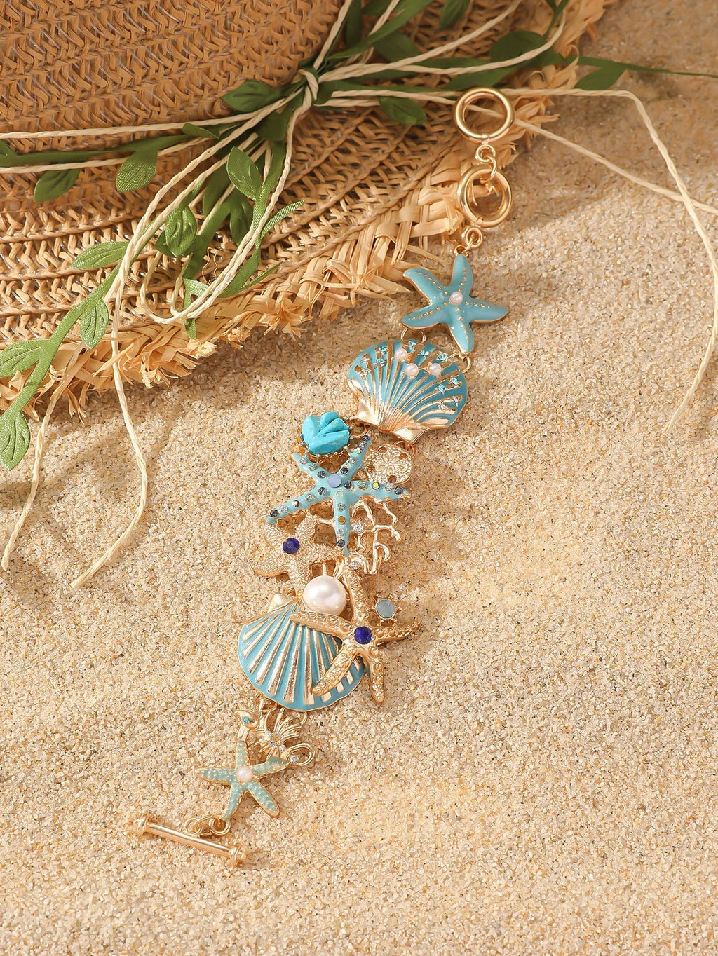 Alloy rhinestone bracelet with boat anchor, shell, and starfish charms in turquoise, red, or blue.