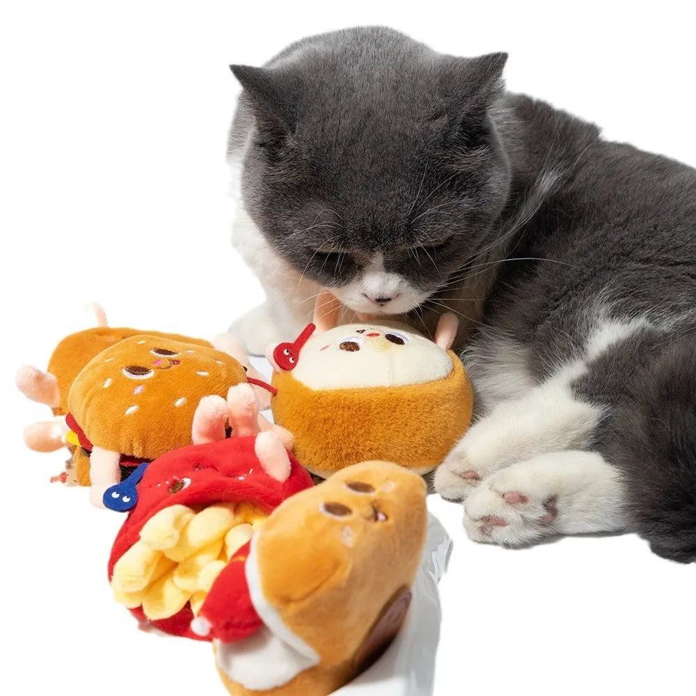 Five cat teething toys shaped like hamburger, chicken leg, fries, hot dog and bread on white background