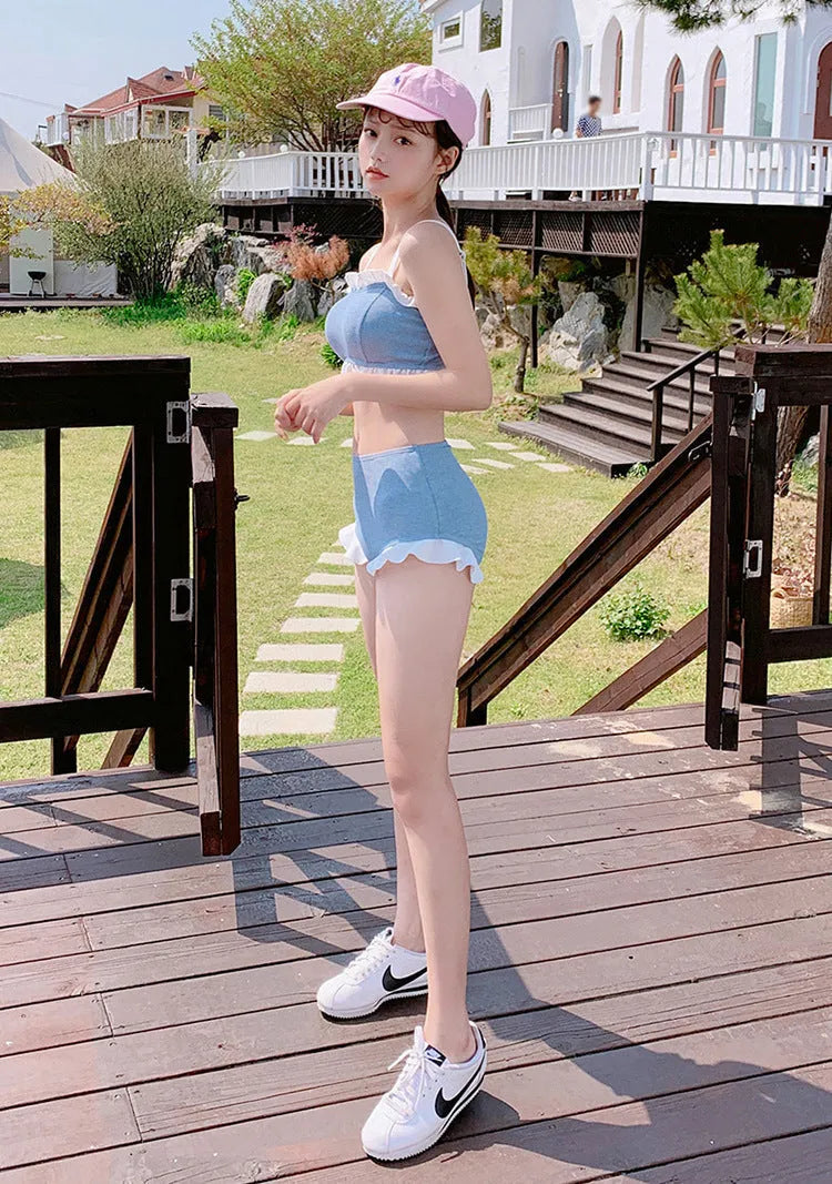 Women's solid colour one-piece swimsuit with fashion suspender straps, conservative cut for swimming.
