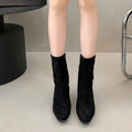 Women's brown square toe ankle boots with a side zip and a stiletto kitten heel on a white background.