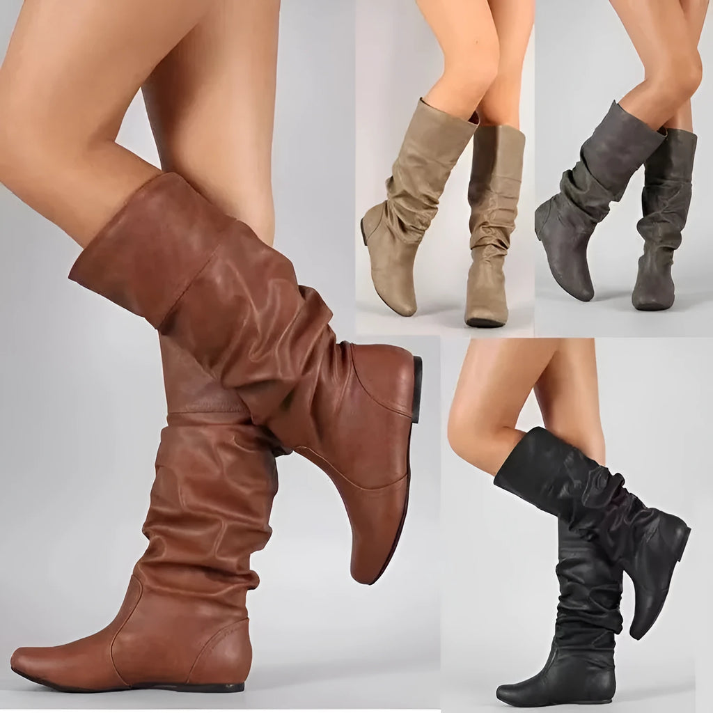 Women's flat heel knee-high slip-on boot in black with round toe and rubber sole