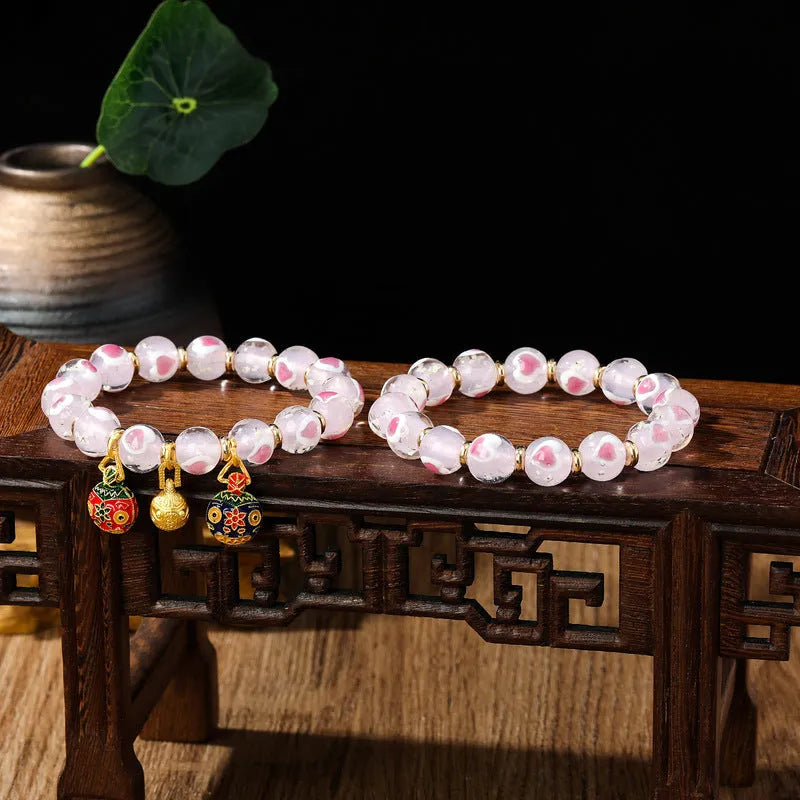 Handmade glass bracelet with swallowing gold beast design on heart-shaped 10mm beads
