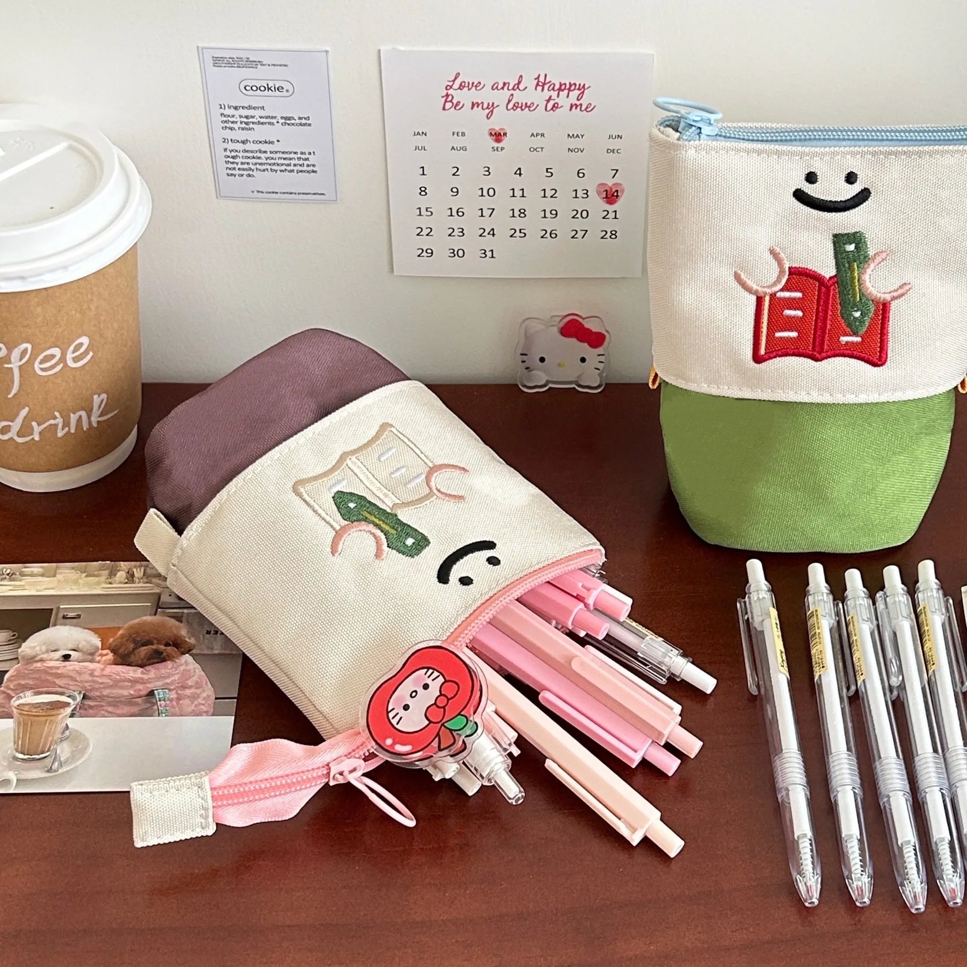 Brown Korean style cartoon print collapsible oxford fabric pencil case open on a table.