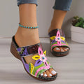 Women's cowhide sandals with coloured slope heel and totem pattern in black, purple, green, and orange.