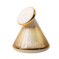 Champagne gold night table lamp with integrated magnetic wireless charging seat on its base.