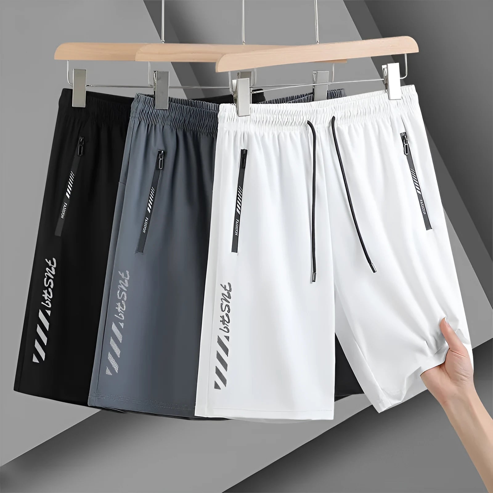 Men's black loose-fit quick-dry nylon sports shorts on a grey background.