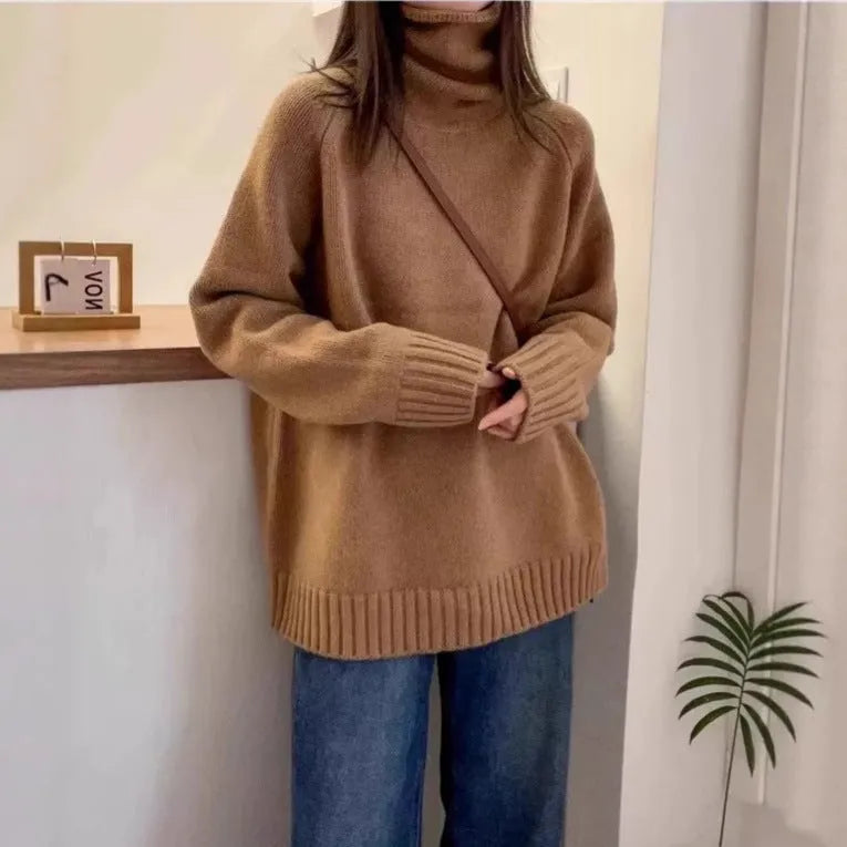 Women's loose fit grey turtleneck sweater with a thick curling pile collar on a hanger.