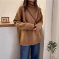 Women's loose fit grey turtleneck sweater with a thick curling pile collar on a hanger.