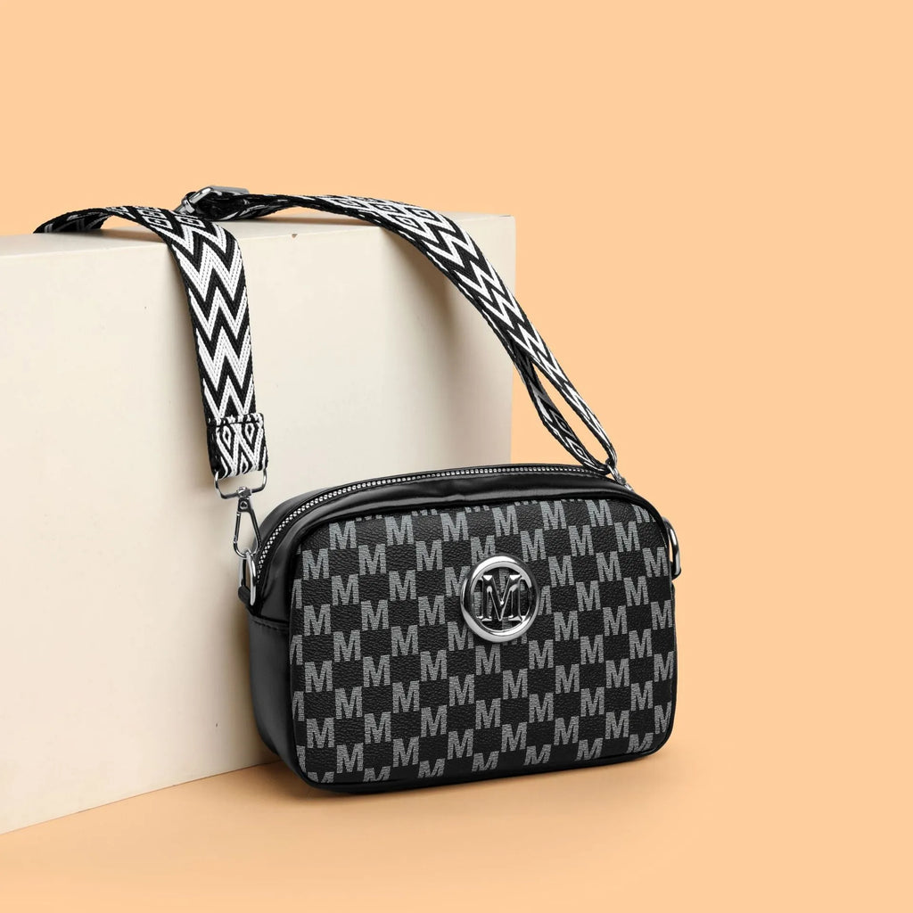 Soft PU crossbody shoulder bag in black with a wide strap and a three-dimensional front pocket.