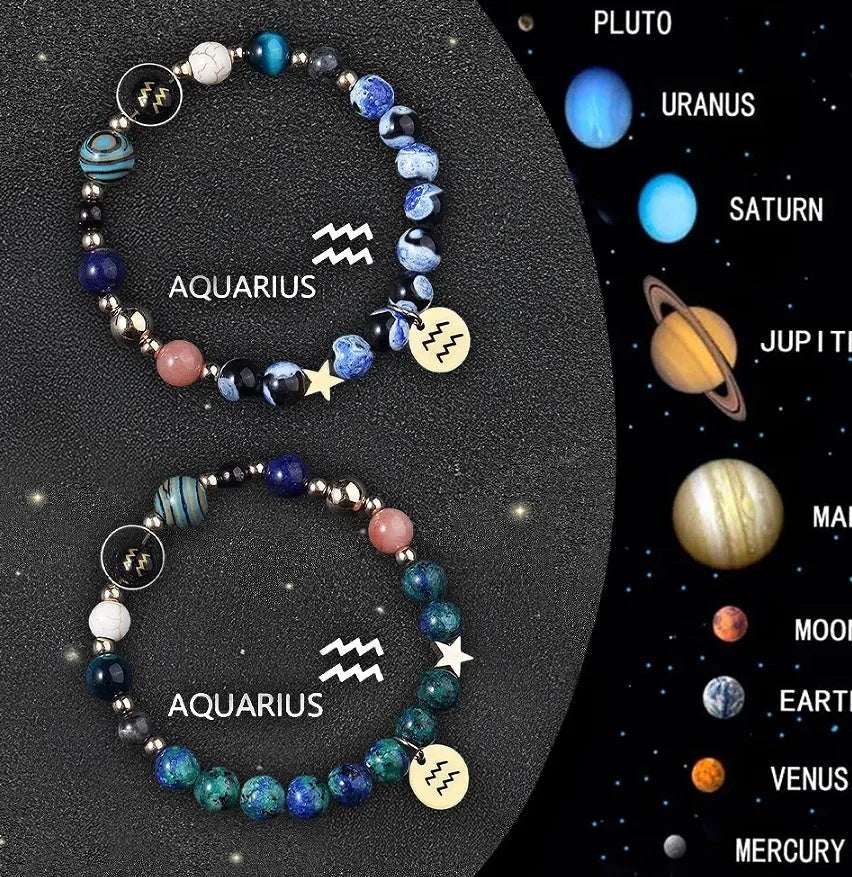 Two natural stone beaded bracelets with sterling silver zodiac charms on a wooden surface.