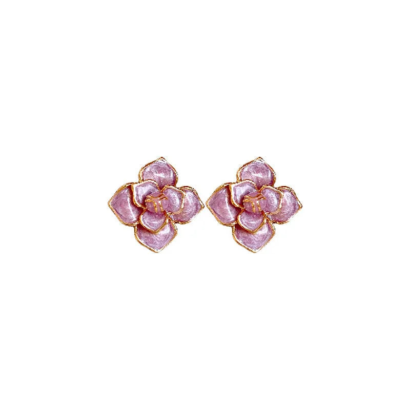 Gold plated stud earrings with a purple oil-spot glaze flower design on a copper base.