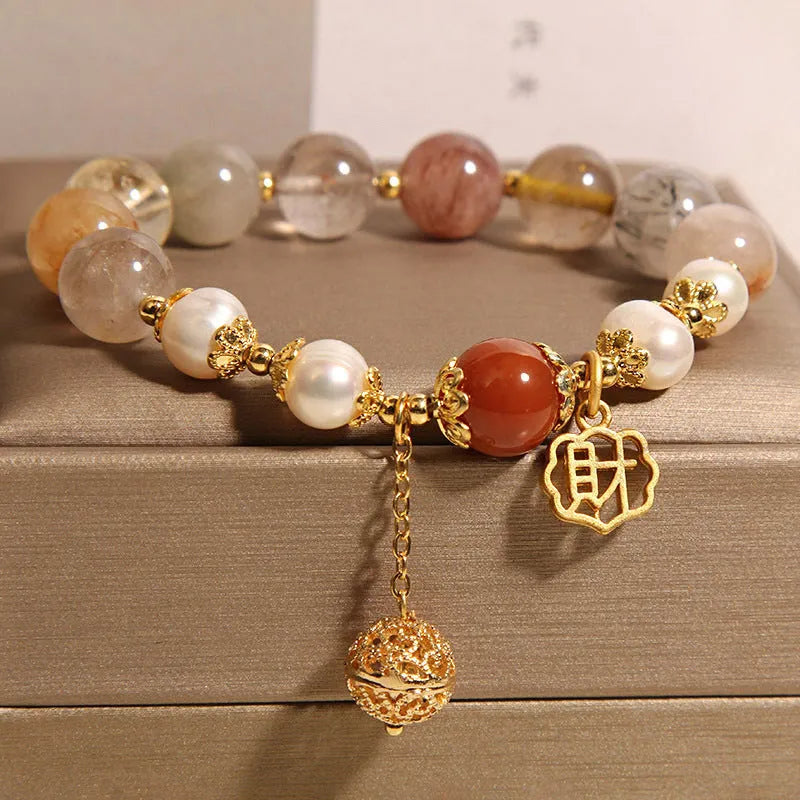 Women's Japanese-style crystal bracelet with pearls and Chinese 'Cai' character charm.