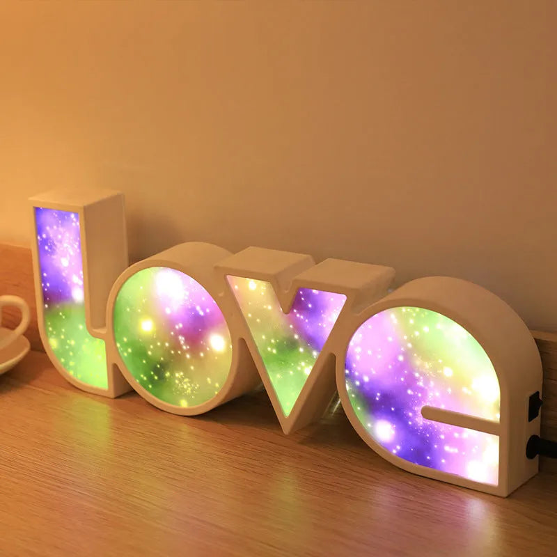 Rainbow style plastic LOVE LED decorative light on a surface.