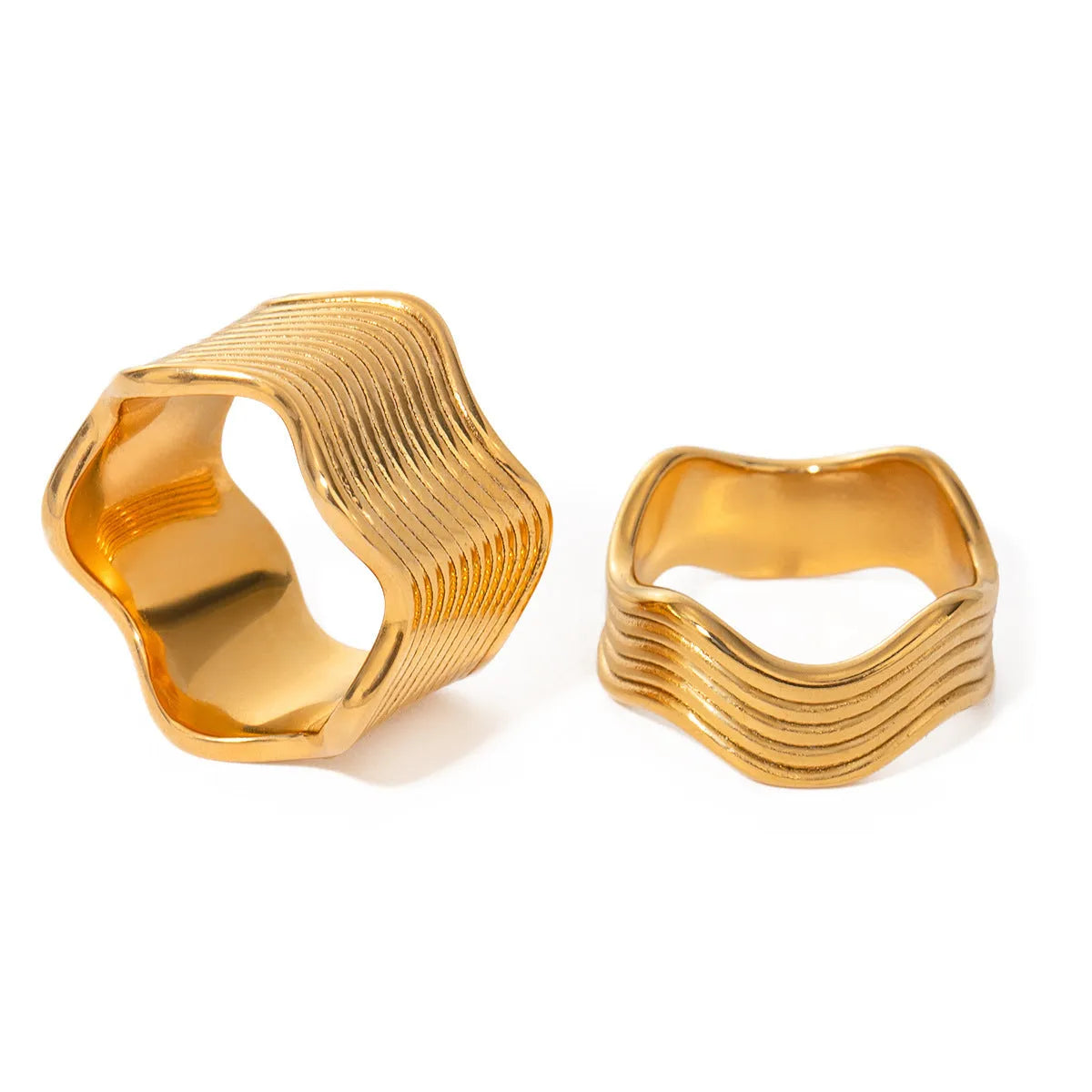 Stainless steel geometric wave ring with a wide band and electroplated finish.