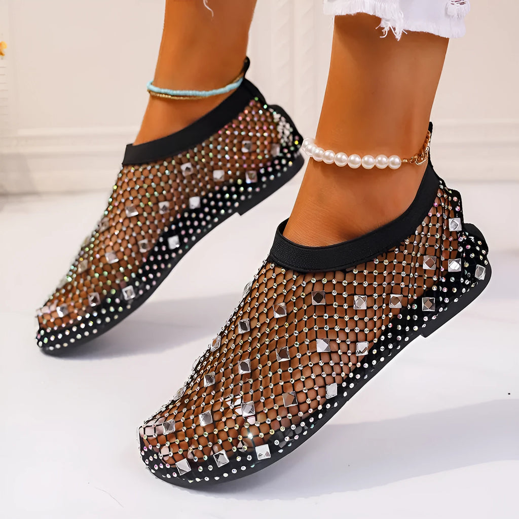 Women's flat mesh sandals with colourful rhinestone detail on a white background.