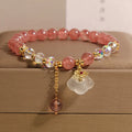 Women's natural crystal bracelet with strawberry quartz beads, white agate beads, and traditional auspicious cloud charm