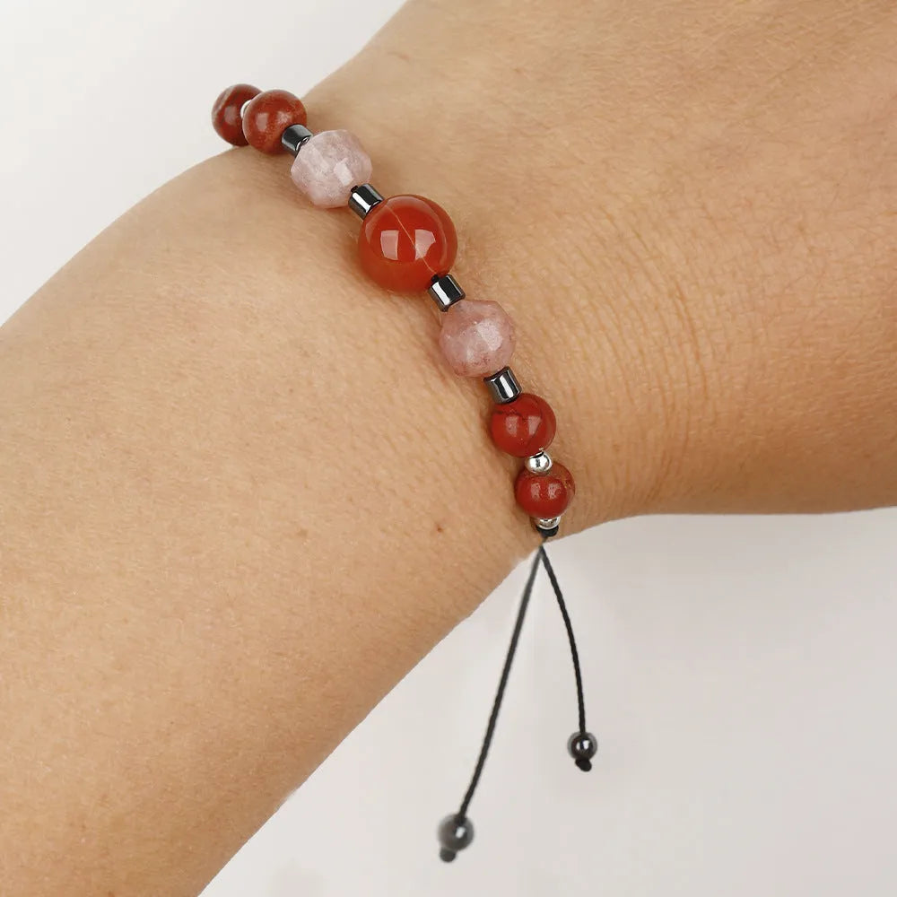 Handmade red geometric bracelet with sunstone, redstone, and copper beads.