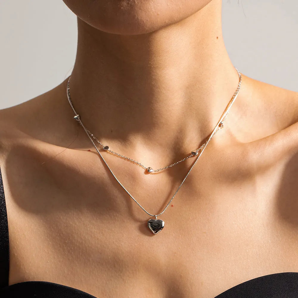 Love double-layer 18K gold-plated collarbone necklace with snake pendant for women on display
