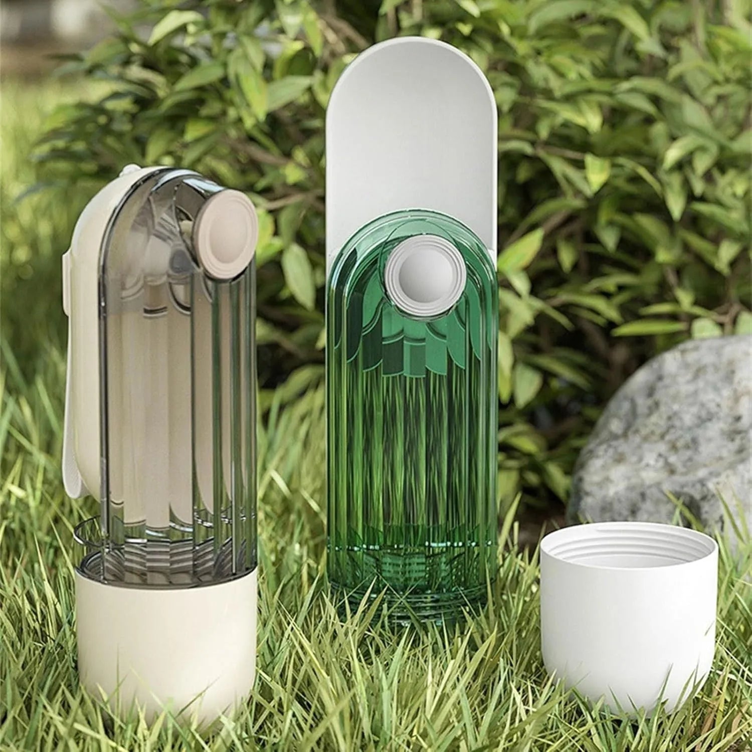 Beige and green foldable dog water bottle with food dispenser for outdoor use.