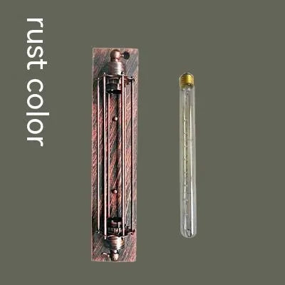 Industrial retro flute shaped iron wall lamp in an antique finish, shown mounted on a wall.