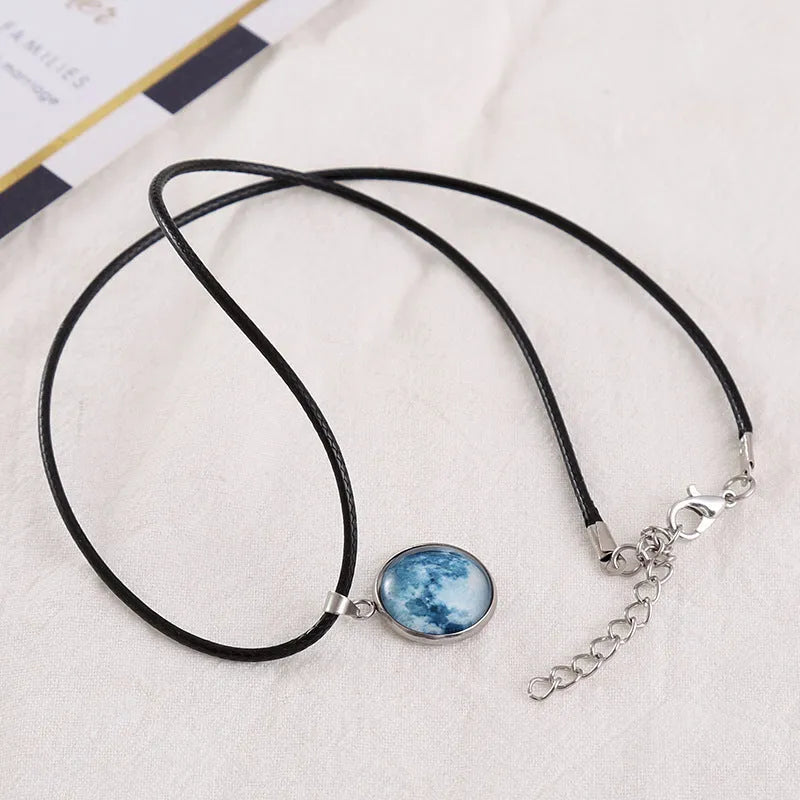 Luminous Christmas moon and starry night sky alloy pendant necklace with coloured glass centrepiece on a chain.