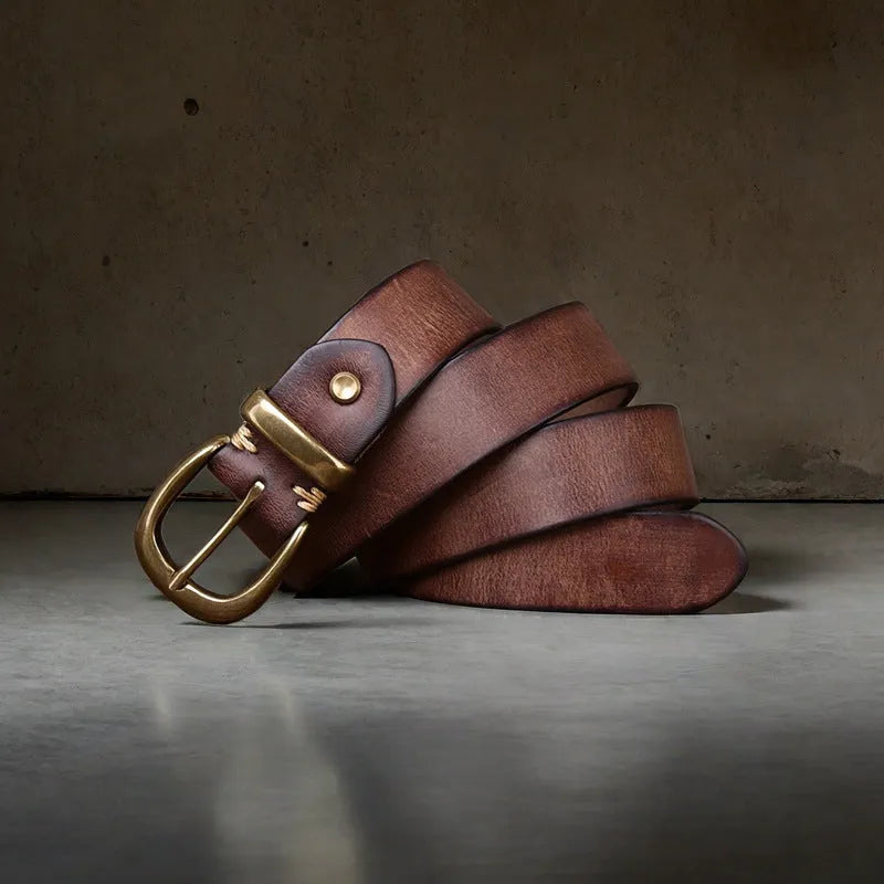 Men's brown leather belt with copper pin buckle on a flat surface