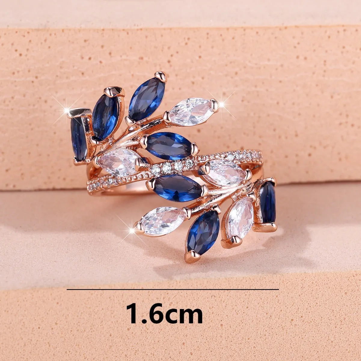 Adjustable copper leaf-shaped ring with a central horse eye zircon stone, shown in a rose gold finish.