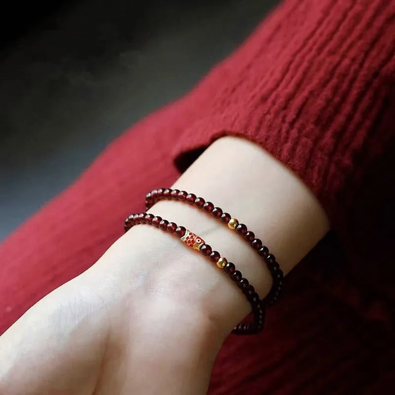 Wine red garnet coloured glass bead bracelet in New Chinese style, shown in single and double circle options.