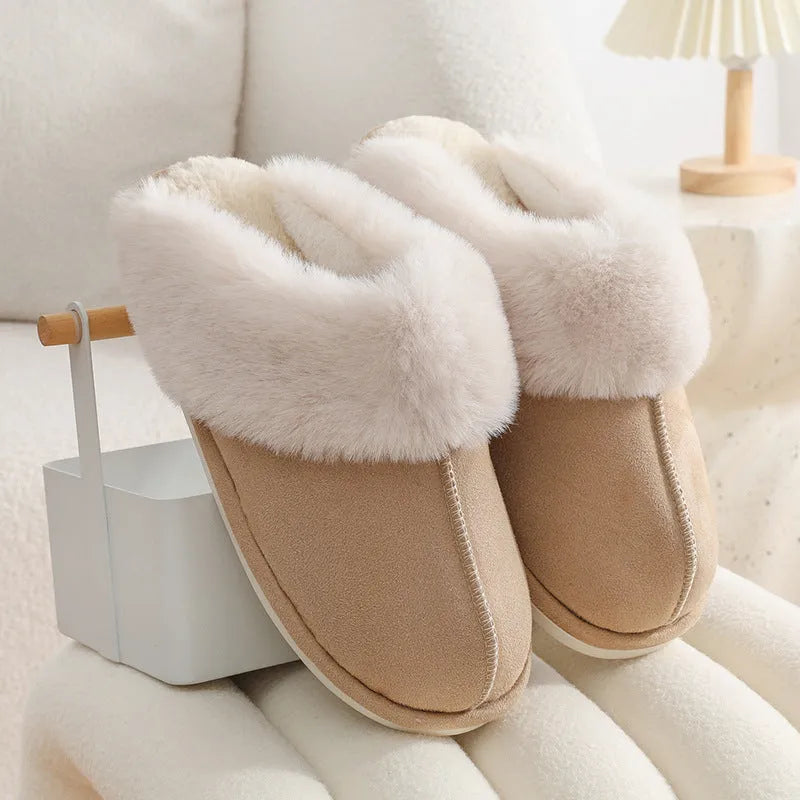 Women's brown plush indoor slippers with a round toe, flat heel, and stitching detail.