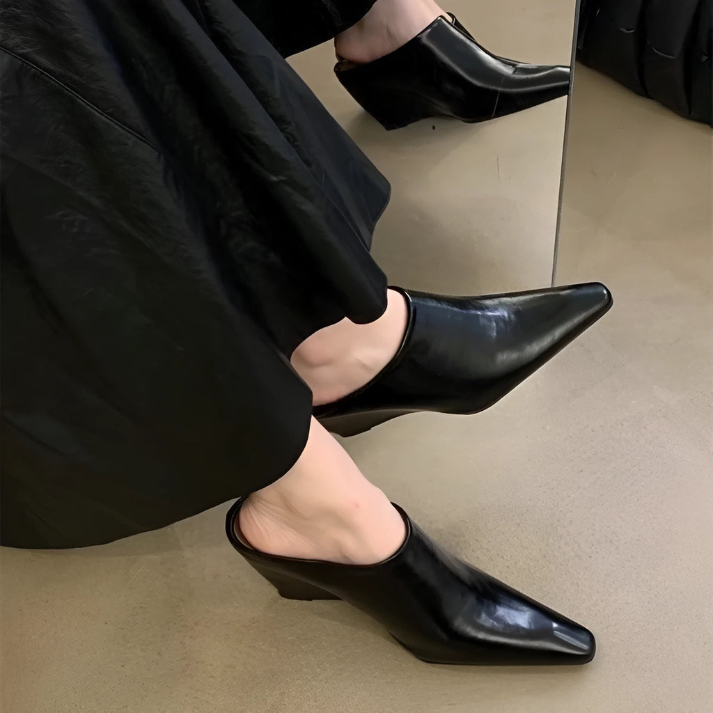 Women's black closed toe wedge half slippers showing PU upper material and wind wedge sole design