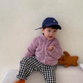 A child wearing a blue sherpa fleece winter coat with a full zip, high collar, and front pockets.