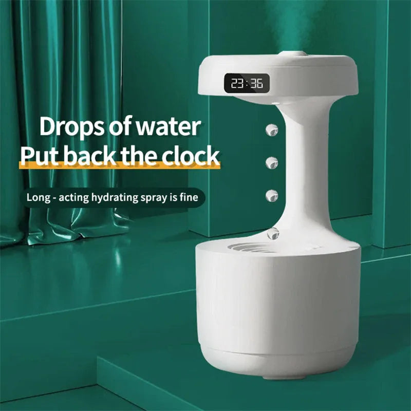 White columnar anti-gravity humidifier with LED clock display and mist output on a wooden desk.