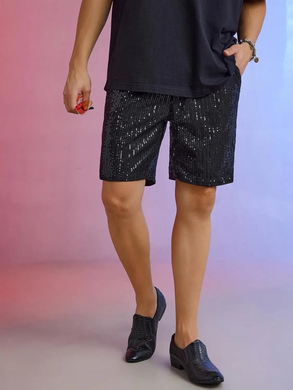 Men's straight-leg shorts with shiny sequins in silver or black, showing elastic waistband.