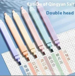 Set of double-headed fluorescent marking pens in bright colours on a white background.