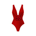 Red V-neck one-piece swimsuit with open back and a detachable long skirt laid flat.