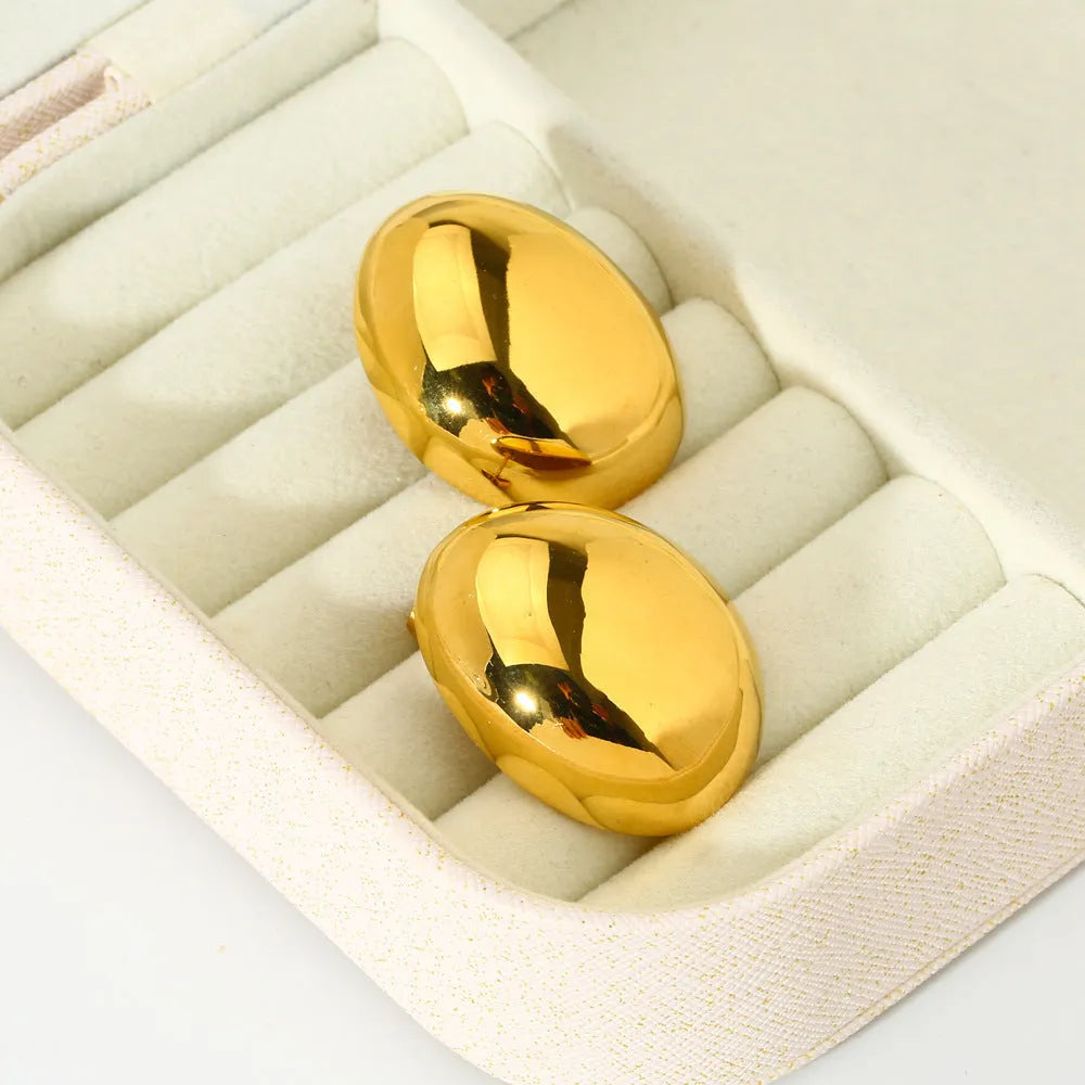 Geometric stainless steel ear studs with 18K gold plating and a glazed surface finish.