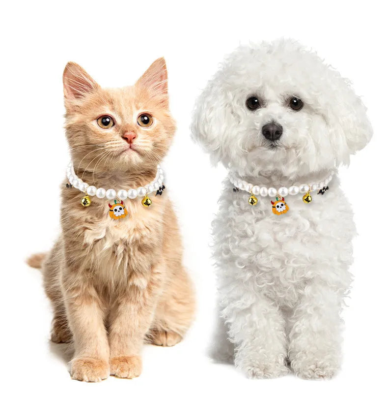Three shiny plastic pearl necklaces with metal bells for pet Halloween costumes on a cat and puppy.