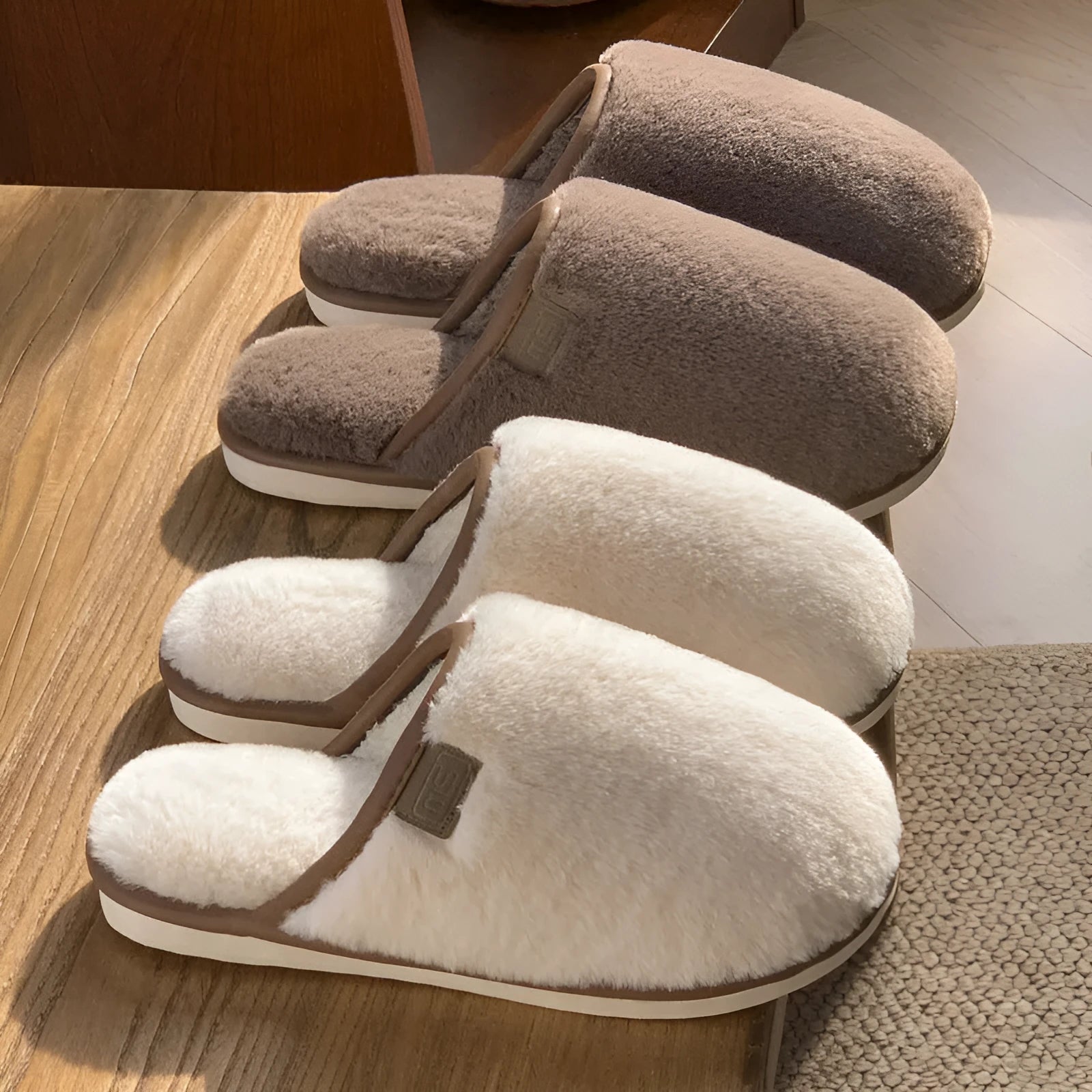 Pair of solid-colour plush winter slippers with a slip-on design and a textured PVC sole.